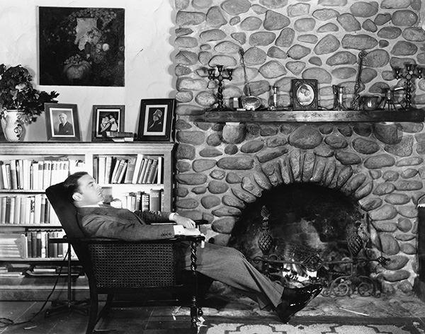 Man sitting next to a fire to stay warm.