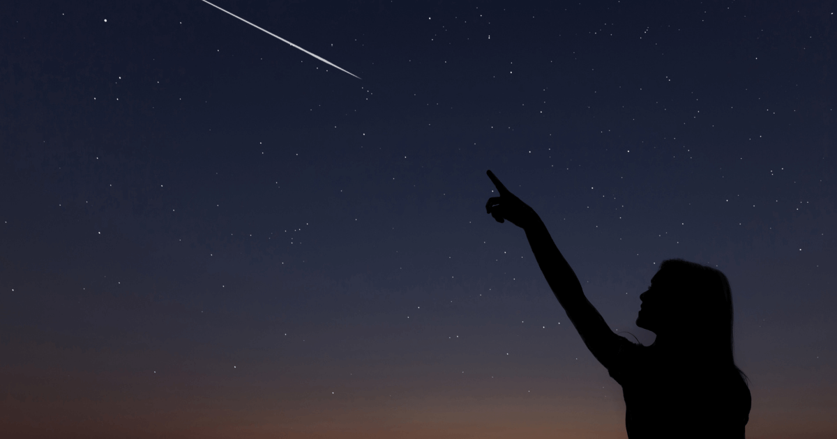 girl pointing at a shooting star