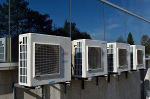 4 air conditioning units on a wall