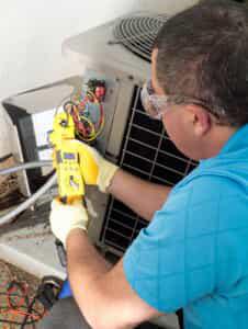 HVAC technician testing AC unit