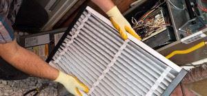 A man putting in a new air filter