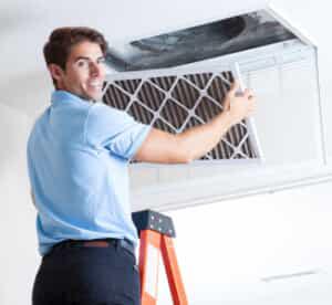 AC technician changing air filter