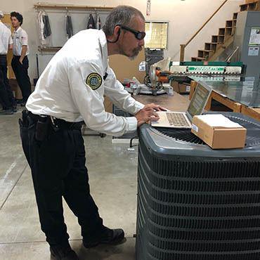 man working on an ac untit