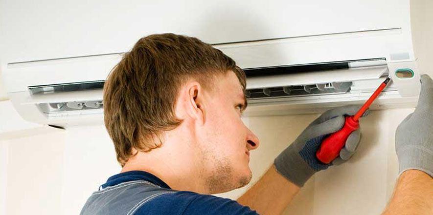 Man working on a ductless mini split AC system 