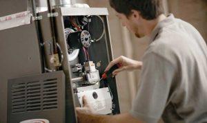 HVAC technician repairing an electric furnace