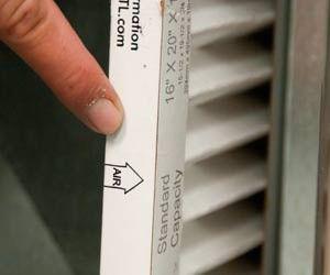 finger pointing at air filter