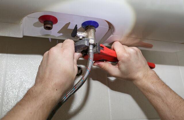 Technician fixing a boiler 