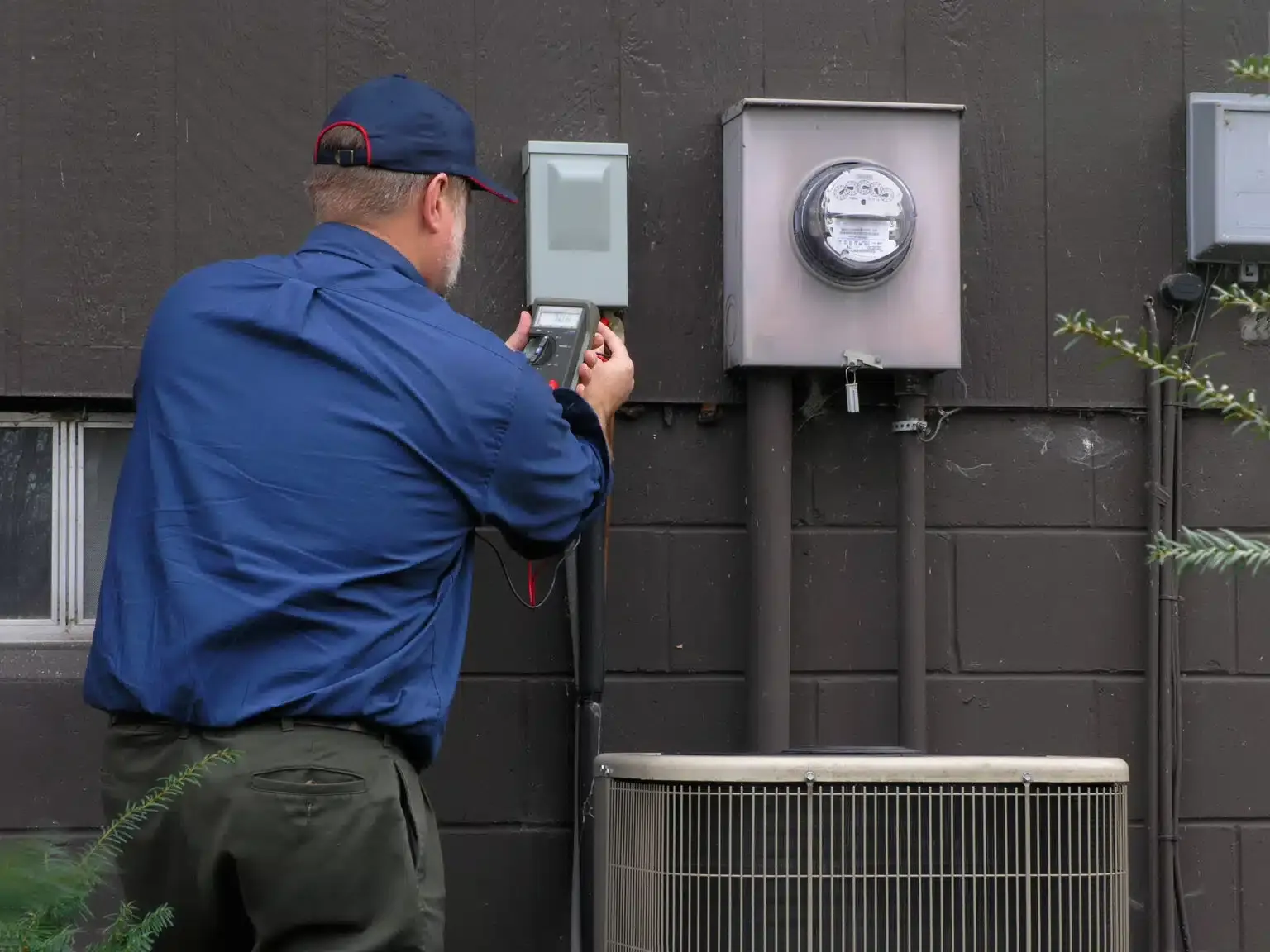 man testing hvac unit