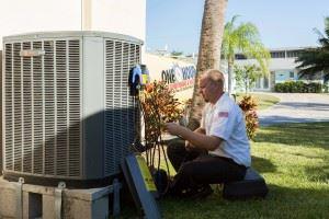 A man installing an HVAC unit