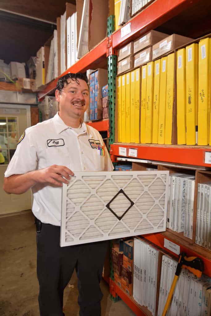 Pass One Hour technician holding air filter