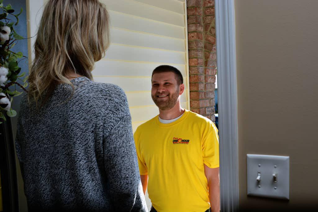 Pass One Hour technician greeting customer at her door