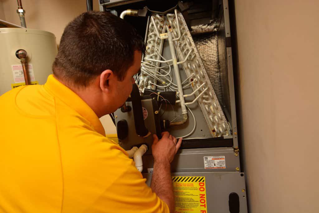 Pass One Hour technician working on HVAC unit