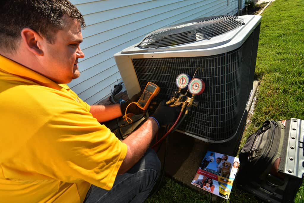 Pass One Hour technician working on an AC unit