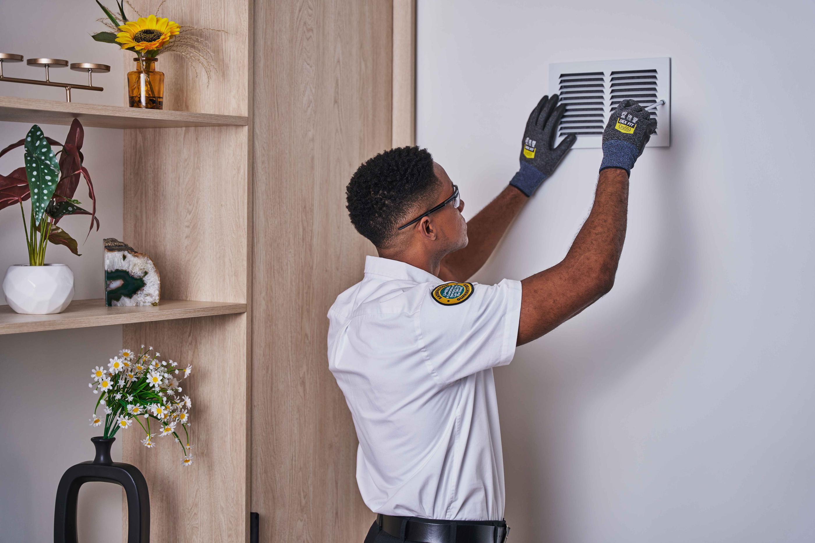 Technician Performing Air Duct Cleaning