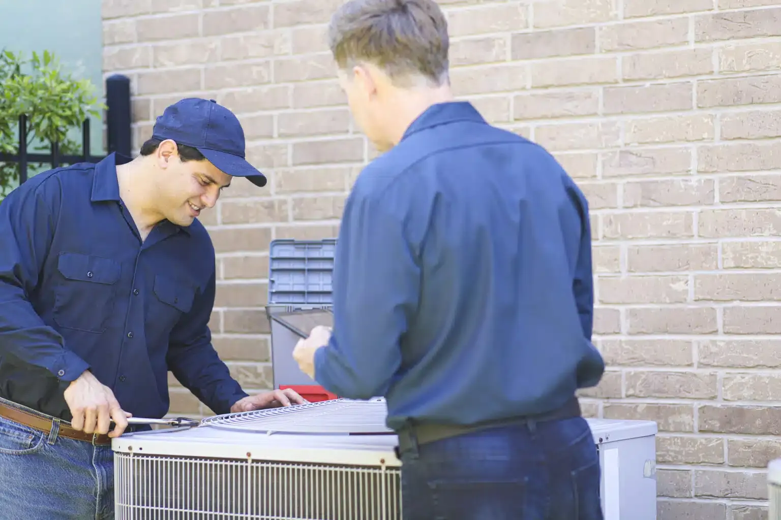 technicians working on AC unit