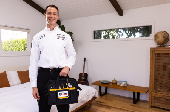 HVAC tech standing and smiling in room