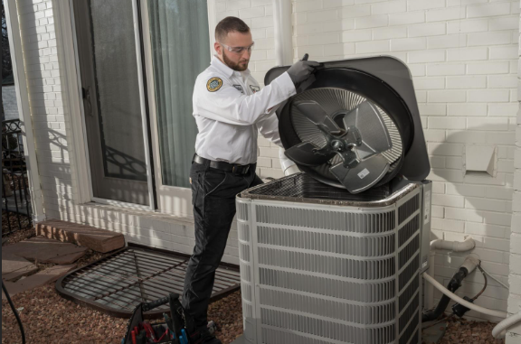 HVAC technician inspecting outdoor unit
