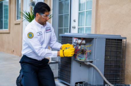 HVAC technician repairing outdoor unit
