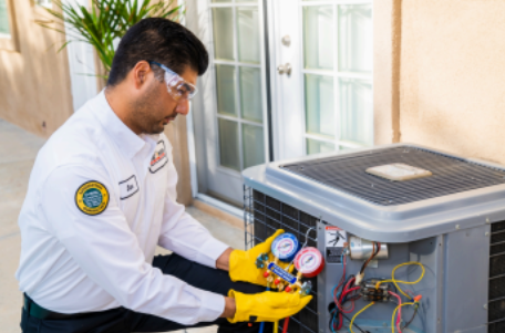 HVAC technician inspecting outdoor unit