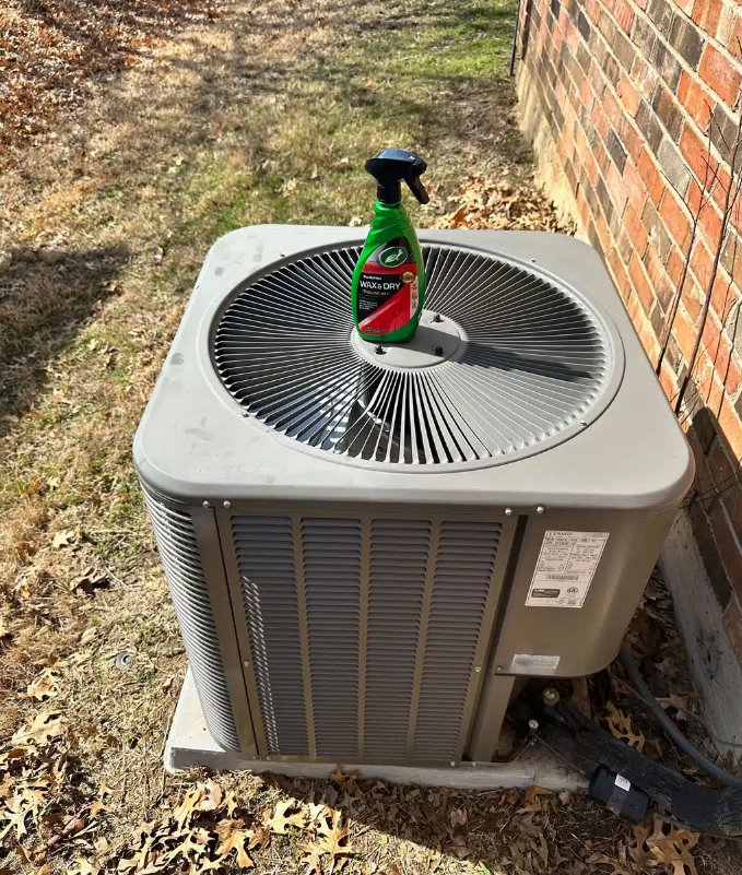outdoor AC unit with bottle on top