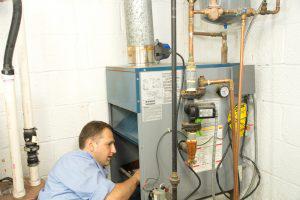 Technician looking at heat exchanger