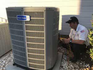 HVAC Technician Tuning Up an AC Unit