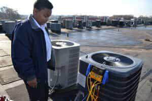 HVAC Technician Observing AC Unit