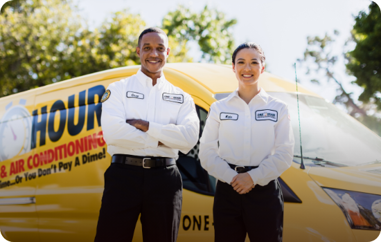 Two One Hour Heating & Air Conditioning technicians standing confidently in front of a service van.